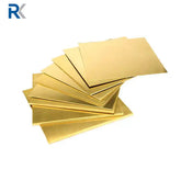 Brass flat sheet laid out on a workshop table, showing a smooth even golden surface