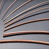 Assortment of pure copper wire in different gauges, from thin fine wire to thick solid wire