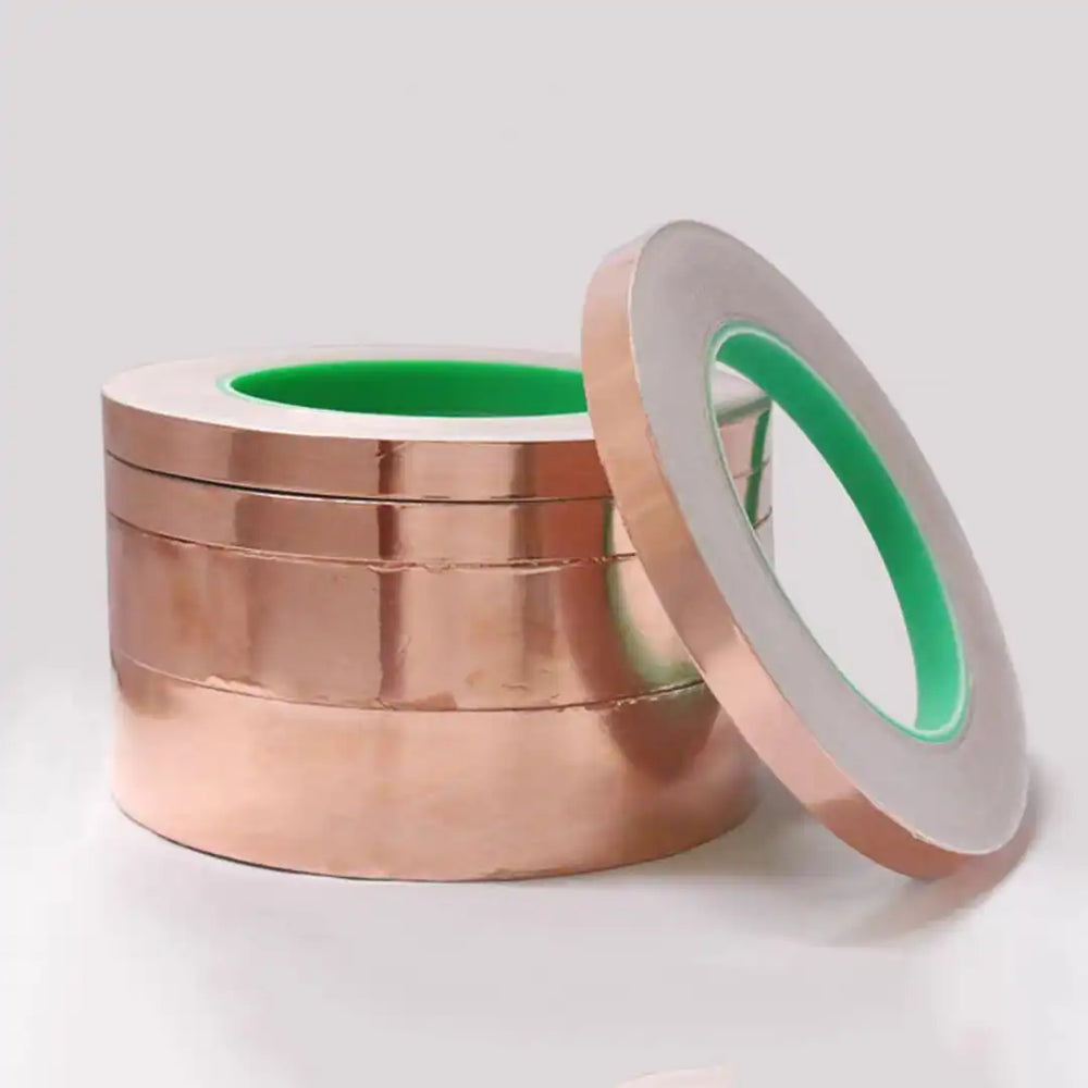 Close-up of conductive adhesive backing on double-sided copper foil for electrical grounding